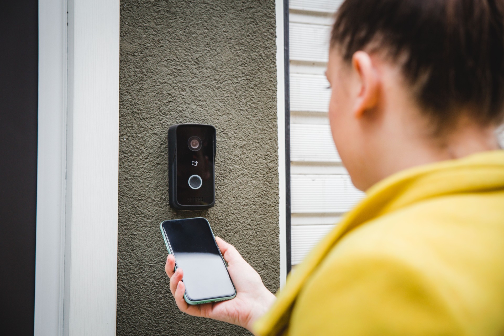 Woman using a phone to enter an office